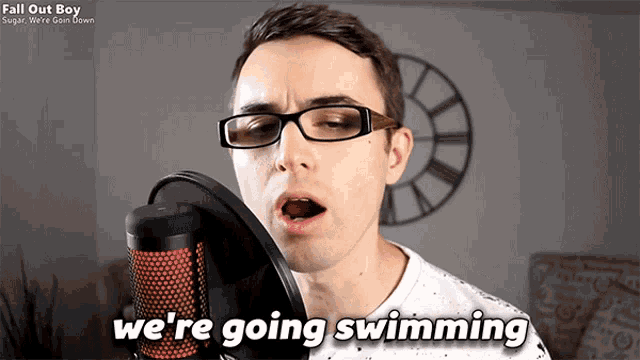 a man singing into a microphone with the words " we 're going swimming " next to him