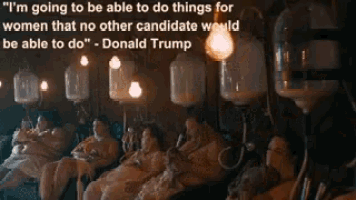 a group of people are sitting in a dark room with a quote from donald trump