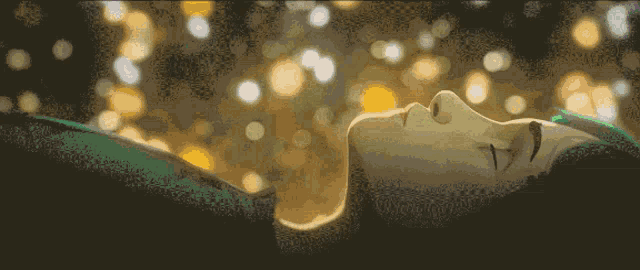 a close up of a person 's face with a blurry background of lights
