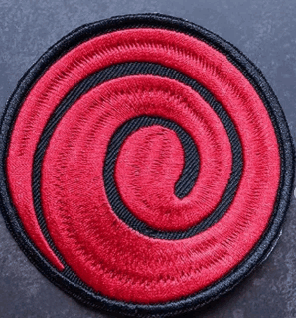 a red and black circle with a swirl in the center