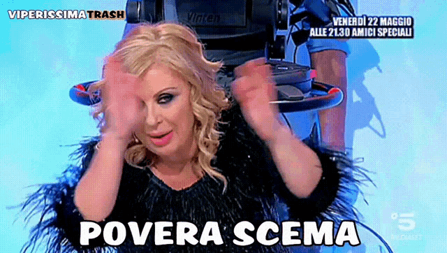 a woman in a black feathered dress says " povera scena " in front of a camera