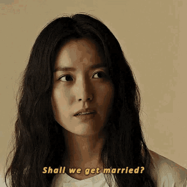 a woman with long hair is asking shall we get married .