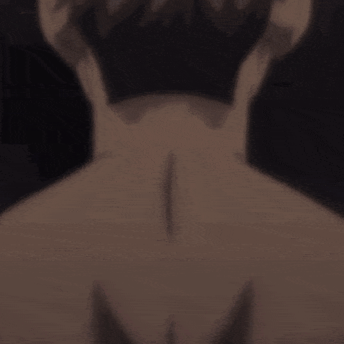 a close up of a person 's back with a triangle tattoo on it