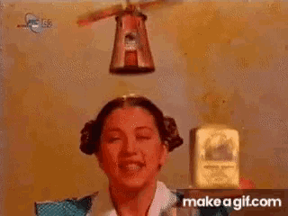 a woman blowing a kiss while holding a box that says ' make a gif.com '