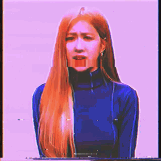 a woman with long red hair is wearing a blue turtleneck and a blue shirt .