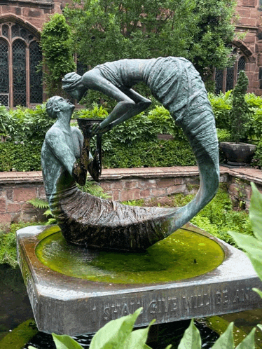 a statue of a man and a mermaid with the words " i shall give will be an " on the bottom