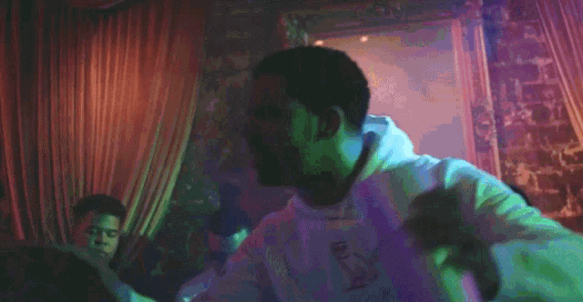 a man in a white hoodie with the letter o on the front