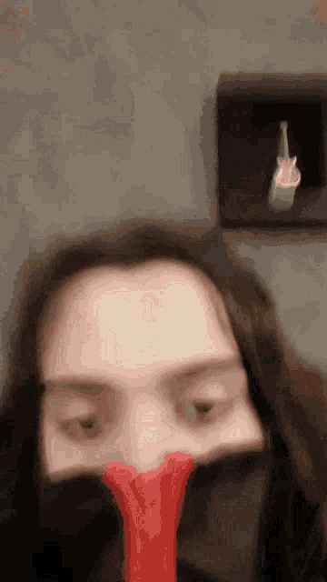 a woman covering her face with a red object