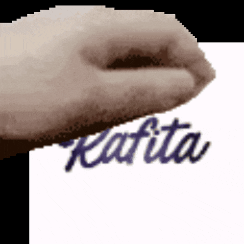 a close up of a hand holding a piece of paper that says ' kafka ' on it