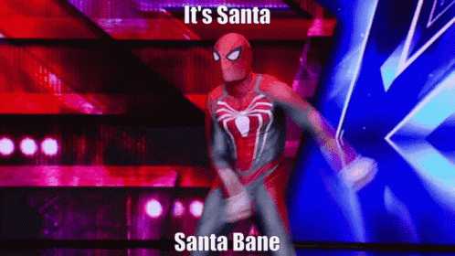 a man in a spiderman costume is dancing on a stage with the words `` it 's santa santa bane '' above him .