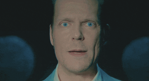 a close up of a man 's face with his mouth open and the word aah visible in the corner