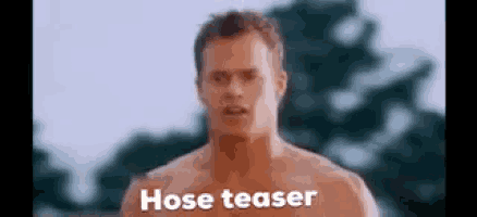 a shirtless man is standing in front of trees with the words hose teaser written on his chest