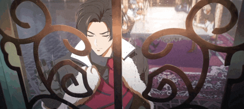 a man with a scarf around his neck is standing in front of a wrought iron gate
