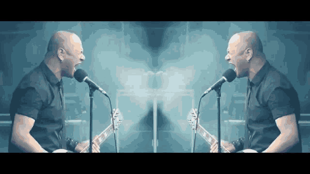 a man singing into a microphone next to another man singing into a microphone