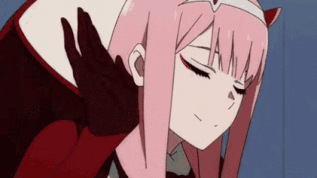 a close up of a person 's hand touching a girl 's head .