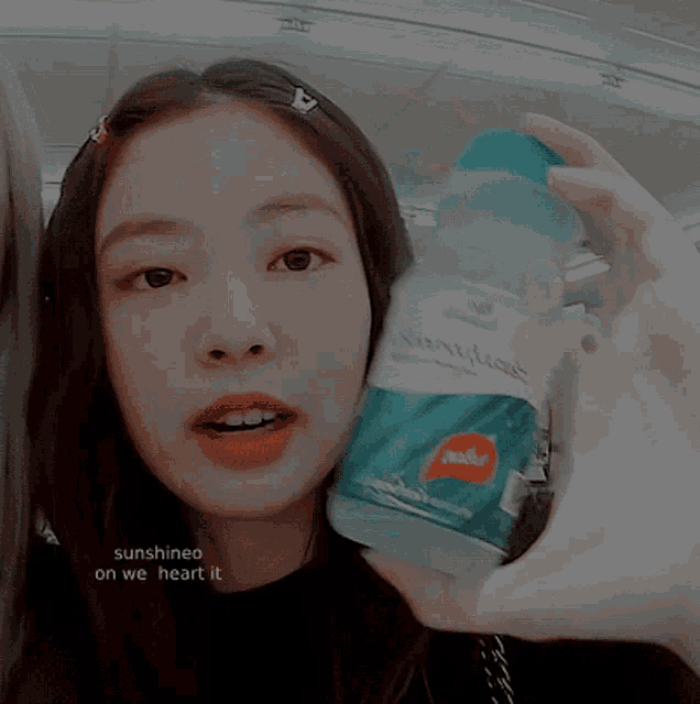 a woman holding a bottle of water with the words sunshineo on we heart it