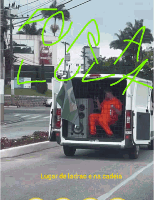 a man in an orange jumpsuit sits in the back of a van