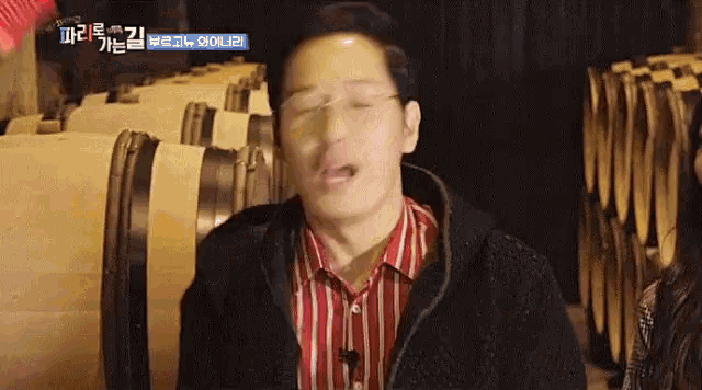 a man in a striped shirt is making a funny face