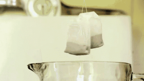 a tea bag in a measuring cup with a label that says raspberry