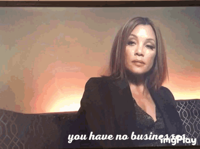 a woman sitting on a couch with the words " you have no business " written below her