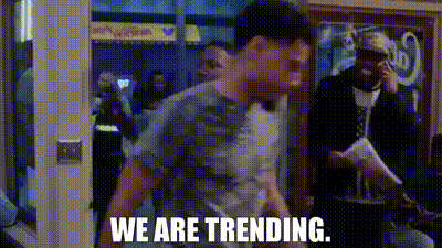a man is standing in a doorway with the words `` we are trending '' written on the bottom .