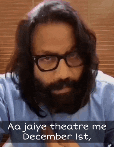 a man wearing glasses and a beard says aa jaiye theatre me december 1st