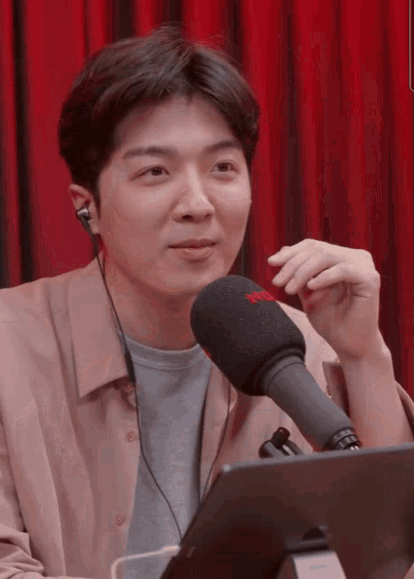a man wearing headphones and a microphone that says rode on it