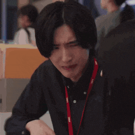 a man with his hands folded in front of his face .