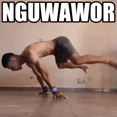 a man without a shirt is doing a handstand in front of a wall that says nguwawor