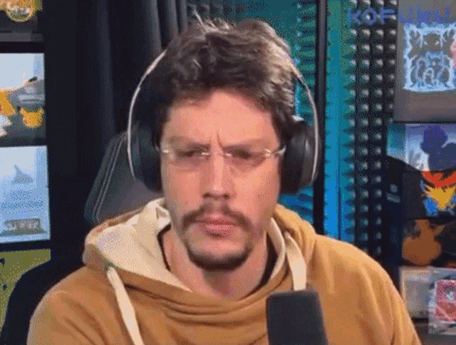 a man with a beard wearing headphones and glasses
