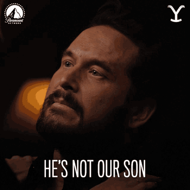 a man with a beard has the words he 's not our son written on his face