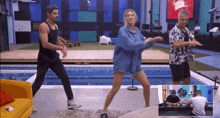 a group of people dancing in front of a pool