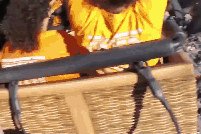 a person wearing a yellow shirt that says ' a ' on it