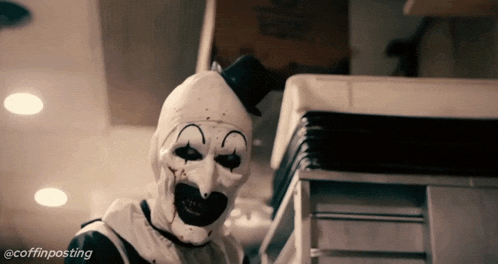 a clown with a top hat is standing in front of a stack of boxes with the hashtag @coffinposting on the bottom