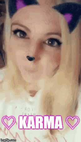 a woman wearing cat ears and the word karma on her face