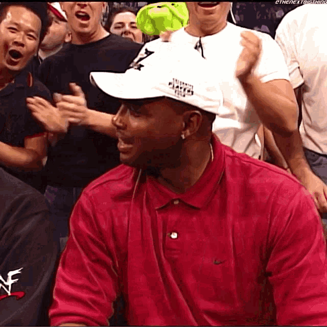 a man wearing a white hat that says world heavyweight champions on it