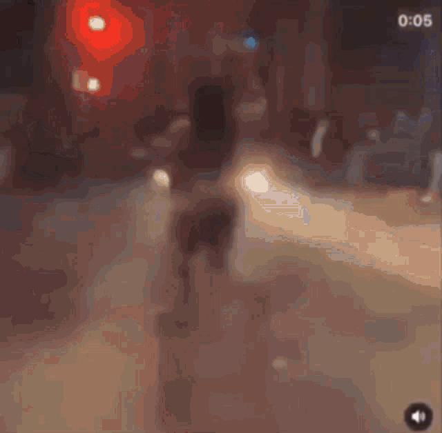 a blurry picture of a police officer talking on a cell phone .