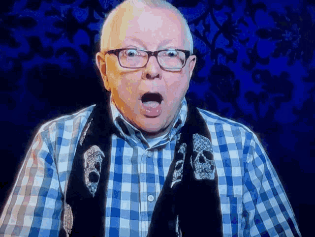 an older man wearing glasses and a scarf with skulls on it