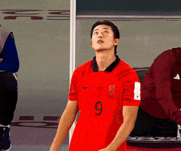 a soccer player in a red jersey with the number 9 on it