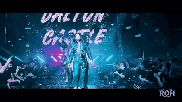 a woman in a blue dress stands in front of a sign that says until i win castle