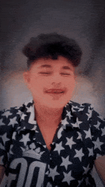 a boy wearing a shirt with the number 20 on it is making a funny face