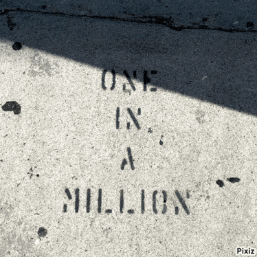 a concrete surface with the words one in a million written in stencil