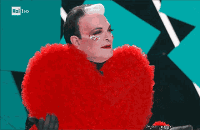 a man in a red heart shaped costume with rai 1 hd on the bottom right