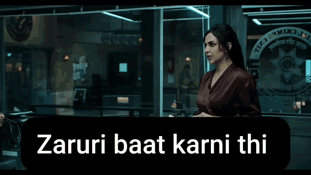 a woman stands in front of a sign that says zaruri baat karni thi