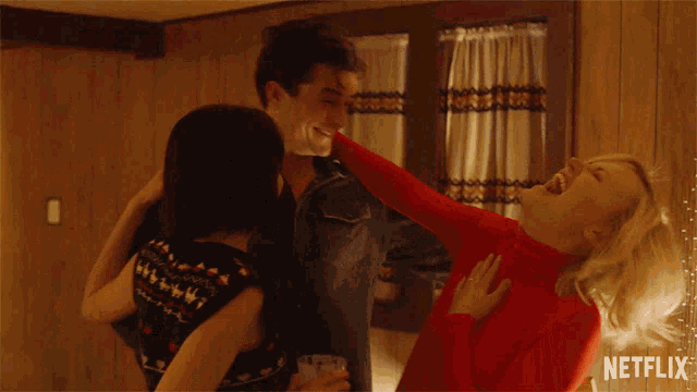 a netflix ad shows a man and two women laughing together