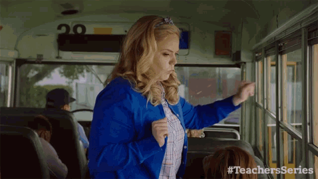a woman in a blue jacket is on a school bus with #teachersseries on the bottom