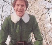 a man in a green elf costume is smiling