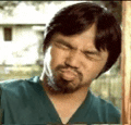 a man with a beard is making a funny face while wearing a green shirt .
