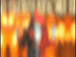 a blurry picture of a person in a red hoodie