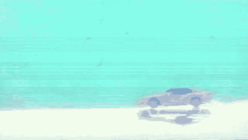 a car is parked on a sandy beach near the ocean .